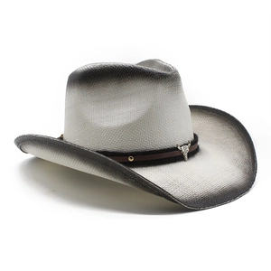 Detail of gradient woven straw cowboy hat with metal bull head and copper rivets