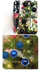 Close-up of blue and black Christmas ornaments with matte, glossy, and glitter finishes