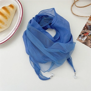 Detail view of blue chiffon scarf with lace stitching and elegant pearl pendant charms