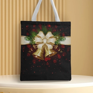 Detail of black canvas Christmas tote bag with gold bells, ribbons and festive print