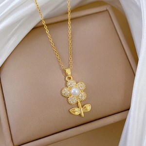 Detail of gold flower necklace with pearls and pavé diamonds on silk background
