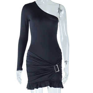 Detail of black one-shoulder dress showing silver buckle, ruching and ruffle hemline
