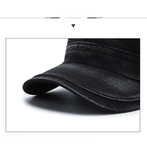 Detail of reinforced stitching on black washed denim flat top army cap brim