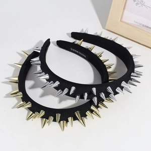 Punk black wide headband with metallic gold and silver cone spikes on white background