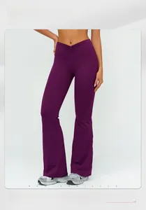 Detail of high-waisted flared yoga pants in dark purple with V-shaped gathered waistband