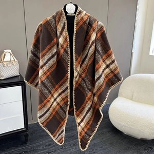Detail view of plaid poncho shawl with soft fabric and decorative edge stitching