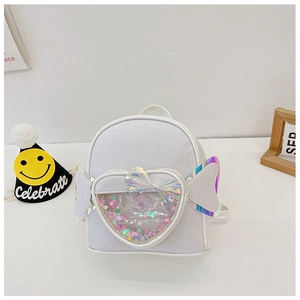 Detail of white sequin heart mini backpack featuring a glitter bow and clear PVC window