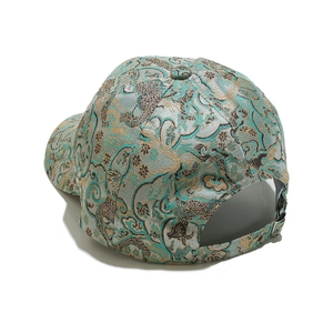 Detail of vintage Chinese brocade baseball cap featuring intricate golden dragon pattern