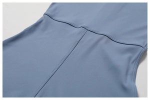 Detail showing precise double-needle stitching on high-stretch blue yoga bodysuit fabric