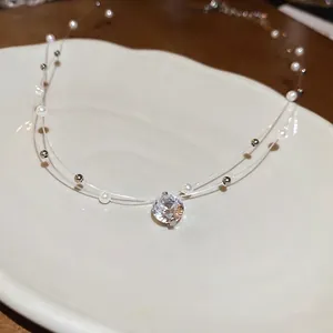 Double-layer zircon and pearl necklace with clear beads on a ceramic tray display