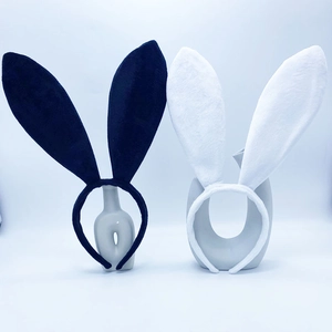 Detail of plush black and white bunny ear headbands on decorative ceramic vases