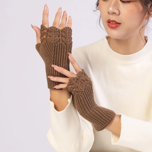 Close-up of brown knitted fingerless gloves with detailed scale-like knit texture