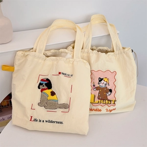 Detail of embroidered canvas drawstring bags with cute dog and cat art designs