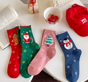 Detailed flat lay of festive cotton Christmas socks with holiday embroidery motifs