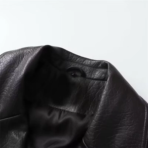 Women's chic black faux leather biker jacket featuring a textured wide lapel collar