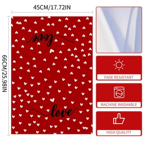 Macro detail of red heart kitchen towel featuring machine washable and fade resistant fabric
