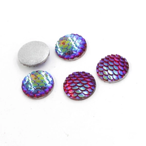 Detailed view of 14mm round mermaid scale resin cabochons with AB iridescent finish