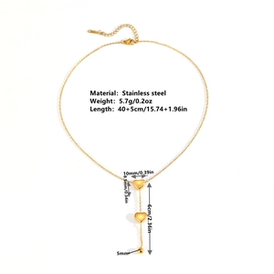 Golden stainless steel necklace featuring two heart pendants and beads on white background