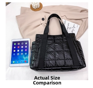 Detail of black quilted puffer tote bag showing spacious capacity for office essentials