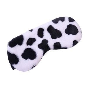 Detail of plush cow print eye mask showing soft faux rabbit fur texture and elastic strap