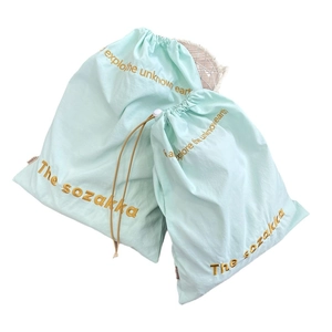 Set of two light blue drawstring storage bags with elegant gold embroidery detail