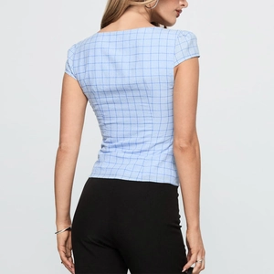 Back view of a slim-fit blue and white plaid short-sleeve knitted shirt for women