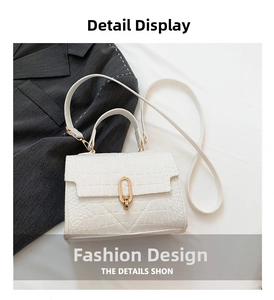 Close-up of white crocodile texture leather with elegant gold ring metal buckle detail