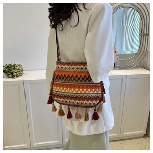 Rear view of bohemian crossbody bag with colorful woven patterns and decorative tassels