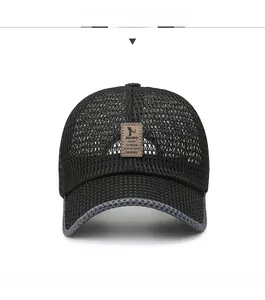 Close-up of black breathable mesh baseball cap with brown leather patch and gray brim edge