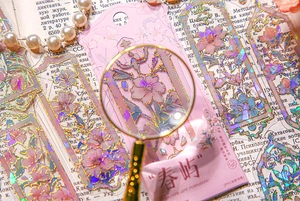 Macro shot of floral PVC bookmark with gold foil details and laser glittering finish