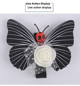 Detailed view of gothic butterfly hair clip with white rose and red skull ornament