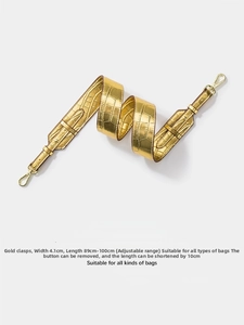 Detailed view of adjustable golden crocodile texture wide shoulder strap with metal clasps