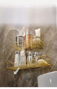 Detail of gold Nordic bathroom shelf showing hollow mesh for drainage on marble wall