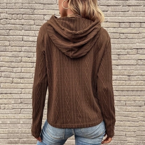 Dettaglio della trama in maglia marrone a rombi e del drappeggio del cappuccio sul retro