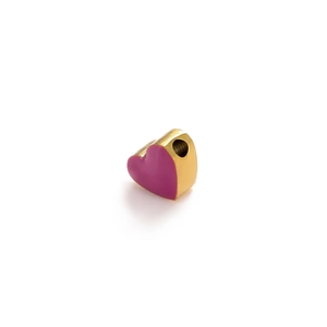 Macro shot of 3D heart charm bead with gold edges and magenta enamel for DIY jewelry