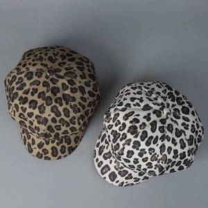 Top view of stylish leopard print newsboy caps in tan and off-white patterns