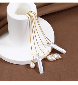 Detailed macro of natural baroque pearls on elegant gold plated sterling silver chain lines