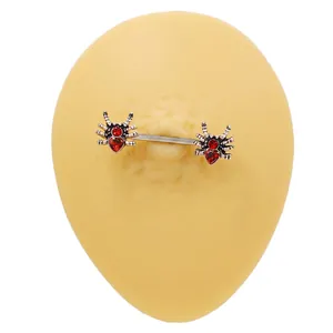 Gothic spider nipple ring set with heart-shaped red gems on a stainless steel bar