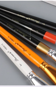 Detail of wooden handle oil paint brushes with high-gloss finish and metal ferrule