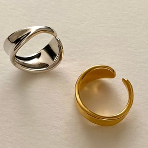 Macro shot of gold and silver S925 sterling silver rings with irregular organic shapes