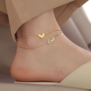 Elegant 18K gold-plated double-layer heart anklet with love pendant on model's ankle