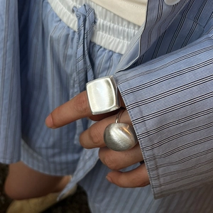 Minimalist silver chunky square ring with matte brushed finish on female model hand