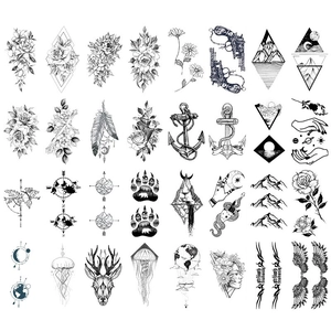 32-piece set of black and white sketch temporary tattoos featuring floral and tribal motifs