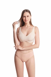 Close-up of beige ribbed cotton thong and seamless bra set on a clean white backdrop