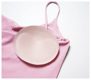 Detail of pink sports bra with high-elastic fabric and removable round chest pads