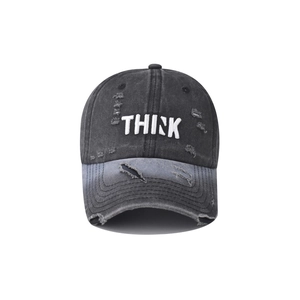 Macro view of white 3D THINK embroidery on distressed washed charcoal grey baseball cap