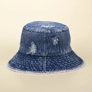 Distressed dark blue denim bucket hat with frayed edges and vintage ripped details