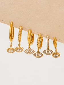 Detailed macro view of 18k gold plated evil eye hoop earrings with white zircon crystals
