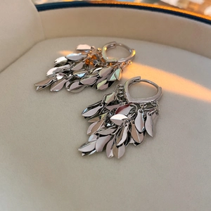 Detailed view of silver leaf tassel earrings featuring layered metallic wheat leaf charms