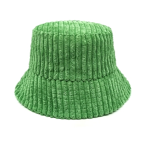 Detailed texture of bright green corduroy fabric on a stylish bucket hat